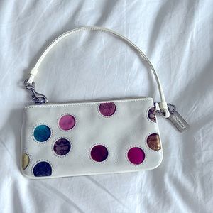 White leather Coach wristlet with multi colored polka dots